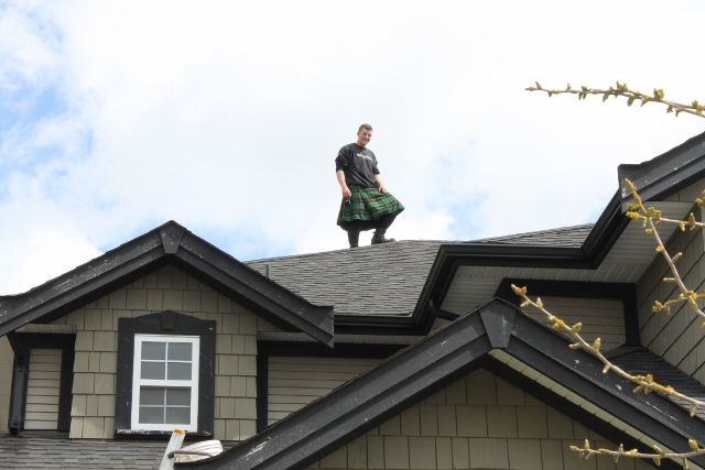 Men in Kilts posing on the roof top